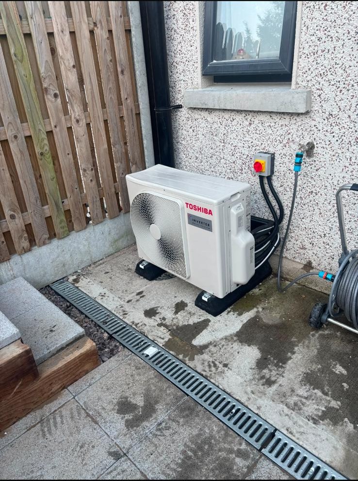 Toshiba outdoor air conditioning unit installed beside an Irish home